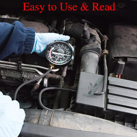Close-up of VECKYJL vacuum gauge tester in a car engine bay, held by a blue-gloved hand with hoses connected.