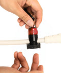 Hands attaching Red Magnetic Regulator Octopus Hose Holder Clip For Scuba Diving Gear to a white hose
