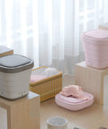 Game Changer Portable Foldable Mini Washing Machine And Dryer Compact Electric Laundry System For College Dorms And RV Trips Rapid Cleanup Spin Cycle in gray and pink, placed in a bright room.