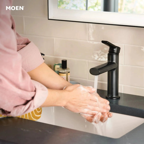 Hands washing under Meena One Handle Bathroom Sink Faucet Matte Black With Drain Included And Optional Deck Plate Ready To Install