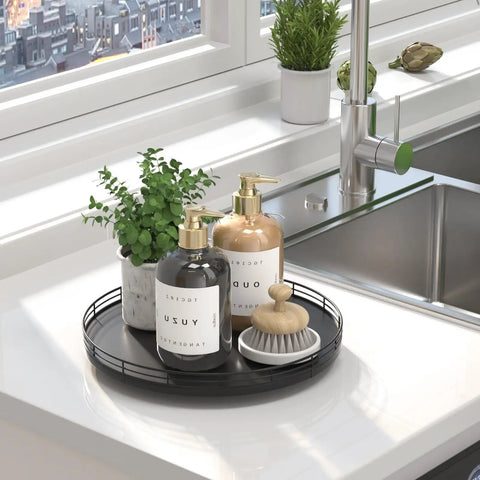 Rock Solid 12 Inch Black Oak Lazy Susan Turntable Tray holding soap bottles and a brush on a bathroom counter.