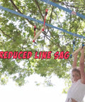 Kid playing on monkey bars with ninja slackline in backyard, marketing text says 'Reduced Line Sag', sunny day.
