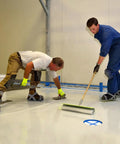 Two workers applying epoxy floor coating wearing Epoxy Floor Spiked Shoes For Garage Fully Assembled Gunite Shoes with 3/4 inch spikes