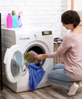 Woman sorting laundry using 12 Pack Tough Nylon Mesh Drawstring Bags 13 By 15.5 Inches With Cord Lock Closure in yellow.