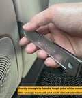 Hand holding 4140 Pry Tool Kit for Car Trim Removal quick pop out mighty miniature portable multitool next to car door panel.