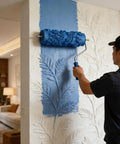 Premium 5 Inch Rubber Patterned Paint Roller Featuring An Ergonomic Handle applying blue paint on textured wall.