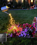 Solar Powered Fairy Lights Outdoor Waterproof 200 LEDs Copper Wire String Lights illuminating garden flowers at night