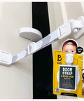 Adjustable Child Proof Door Lock And Cat Door Stopper With Quick Snap Strap Latch on door with gray strap and white latch.