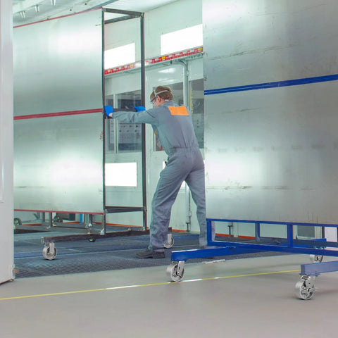 Worker moving panel on Heavy Duty Industrial Casters 6 x 2 Inch With Cast Iron Wheels And Roller Bearings, Galvanized Steel Hubs.