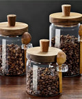 Go Ahead And Upgrade Your Countertop Setup With This Solid Clear Glass Storage Jar Featuring An Airtight Sealed Kitchen Canister And Wooden Spoon For Coffee Beans 900Ml Capacity Handles Dry Goods Smoothly And Looks Dope. Three glass jars with wooden lids and spoons filled with coffee beans.