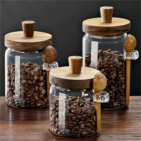 Go Ahead And Upgrade Your Countertop Setup With This Solid Clear Glass Storage Jar Featuring An Airtight Sealed Kitchen Canister And Wooden Spoon For Coffee Beans 900Ml Capacity Handles Dry Goods Smoothly And Looks Dope. Three glass jars with wooden lids and spoons filled with coffee beans.
