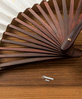Premium Stainless Steel Fan Axle Rivet Kit Six Piece Set 17 To 22 mm Replacement Pins For Folding Hand Fans on wooden surface.