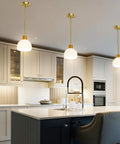 PRTILOUD Pendant Lights Kitchen Island, Modern Gold Hanging Light Fixture with Glass Shade above kitchen island.