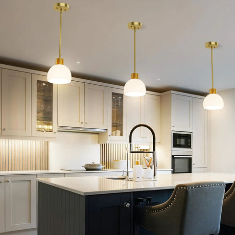 PRTILOUD Pendant Lights Kitchen Island, Modern Gold Hanging Light Fixture with Glass Shade above kitchen island.