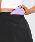 Person placing phone in pocket of High Waisted A Line Golf Skirt With Built In Short Ultra Soft Quick Dry Fabric Black Small