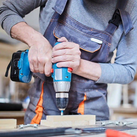 Person using a drill with 100 Piece Heavy Duty Zinc Steel Concrete Anchors, 3/8 Inch Threaded Rod, 1/4 Inch Diameter and 1-1/2 Inch Length.