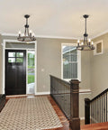 Interior with Wagon Wheel Black Farmhouse Chandelier With 4 Lights in foyer, adding rustic charm and modern yet cozy glow.