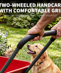 Person holding handle of Heavy Duty Dual Wheel Wheelbarrow Garden Cart With Built In Stand For Yard And Garden in action