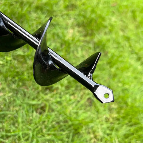 Close-up of black alloy auger spiral bit on grass, part of Auger Drill Bit Set Of 4 For Planting, Garden Spiral Earth Bits For 3/8 Inch Hex Drive Drills