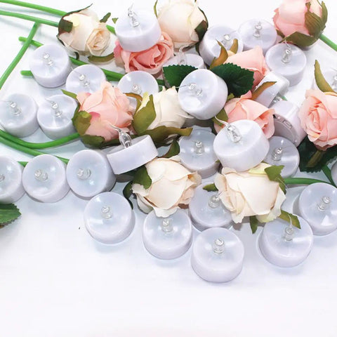 Battery Powered Flickering Flameless Candles With Warm Yellow Glow, Remote Control And 4, 6, 8 Hour Timers in a floral arrangement