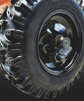Close-up of tire on Beefy 71 Gallon Tow Behind Sand And Gravel Spreader For ATV And UTV