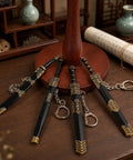 Ancient Sword Letter Opener Set With Sheaths 4 Piece Mini Sword Keychain displayed on a desk with ornamental design.
