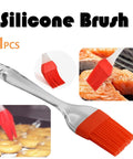 Red silicone brush basting meat and pastries, demonstrating versatility and effectiveness in cooking applications.