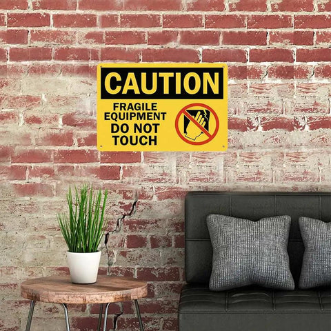 Heavy Duty Aluminum Caution Sign 8x12 In Do Not Touch Notice For Fragile Equipment on a brick wall, yellow and black plaque