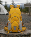 Bright yellow Dope Lightweight Hiking Backpack for Camping and Day Hikes with breathable padded back panel, on a rocky trail