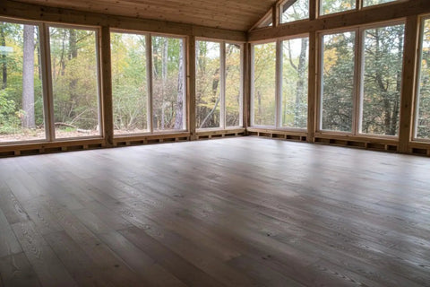 Interior room with large windows and newly stained wood floor using Aged Barrel Reactive Water Based Wood Stain Yields Hella Authentic Vintage Depth.