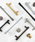 Assorted cabinet pulls and handles, including 96mm Antique Silver Cabinet Pulls 3 3/4 Inch Pewter Dresser Drawer Handles Set of 10, on marble surface.