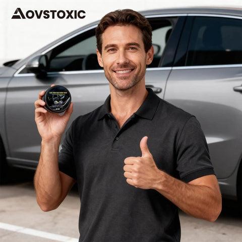 Man holding Ultimate Car Scratch And Trim Restoration Kit For Plastic Vinyl And Rubber Quick 3 In 1 Coating in front of car