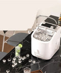 Top Shelf Quick Chill Portable Countertop Ice Maker with ice cubes on a marble table, perfect for parties and easy to clean.