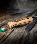 Killer Stainless Steel Folding Pocket Knife With Integrated Wine Corkscrew And Bottle Opener Solid Beechwood Handle on wooden surface.