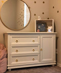 White dresser with 6 pcs brushed brass cabinet ring pulls set in zinc alloy, fits drawers and cabinets, with a round mirror above.