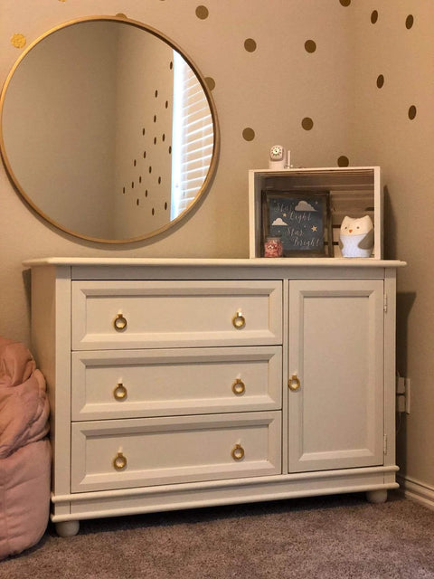 White dresser with 6 pcs brushed brass cabinet ring pulls set in zinc alloy, fits drawers and cabinets, with a round mirror above.
