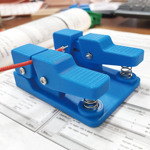 Super Cool Qinkyh Welding Wire Fixture And Soldering Table Clamp That Lets You Handle Any Diameter From 0.3 To 8mm With Ease on a desk.