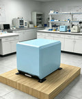 Laboratory with blue equipment on wooden platform, surrounded by lab counters and instruments.