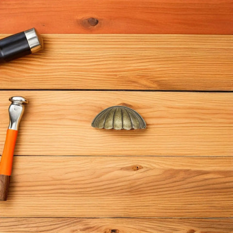 Vintage Shell Cabinet Pulls 4 Pack Antique Bronze Finish Straight Up Heavy Duty Cup Handles on wooden surface.
