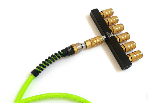 Six Way Air Manifold With One Quarter Inch NPT Quick Connect, Industrial Pneumatic Splitter with brass fittings and green hose.
