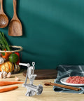 Manual Corn And Grain Mill With High Hopper Cast Iron Hand Crank for Domestic Use on kitchen counter with vegetables