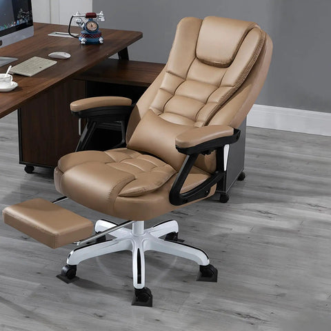 Office chair with tan leather upholstery on a grey wood floor, featuring caster wheels. Furniture setting includes a brown desk.