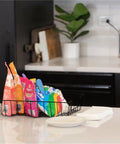 Wire Desk Tray Organizer For Letter And Legal Size Papers Black 5 Inch Buildable File Bin holding snack bags on a kitchen counter.