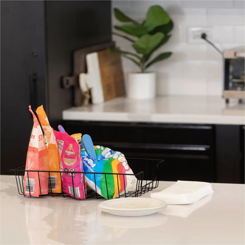 Wire Desk Tray Organizer For Letter And Legal Size Papers Black 5 Inch Buildable File Bin holding snack bags on a kitchen counter.