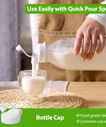 Pouring milk from 32 Oz Glass Milk And Juice Bottle Set With No Leak Airtight Screw Lid and Silicone Gasket into a glass