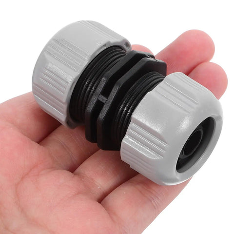 Get Your Garden Hose Back In Action With This Sturdy 4 Piece Repair Kit Featuring Quick Connect Adapters That Make Installation A Breeze For Watering Plants And Keeping Everything Leak Free. gray plastic hose repair connector in hand