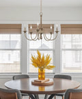 24-Inch Five-Light French Country Chandelier With Adjustable Height In Smoked Birch And Black Finish hanging over dining table.