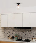 Harrow 1 Light Semi-Flush Mount Ceiling Light With Matte Black Finish, Gold Accent Socket, Clear Glass Shade installed in kitchen
