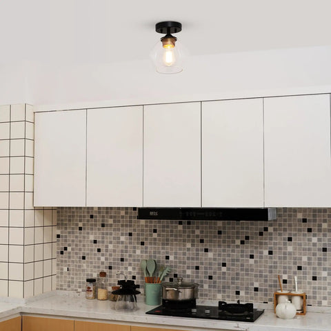 Harrow 1 Light Semi-Flush Mount Ceiling Light With Matte Black Finish, Gold Accent Socket, Clear Glass Shade installed in kitchen