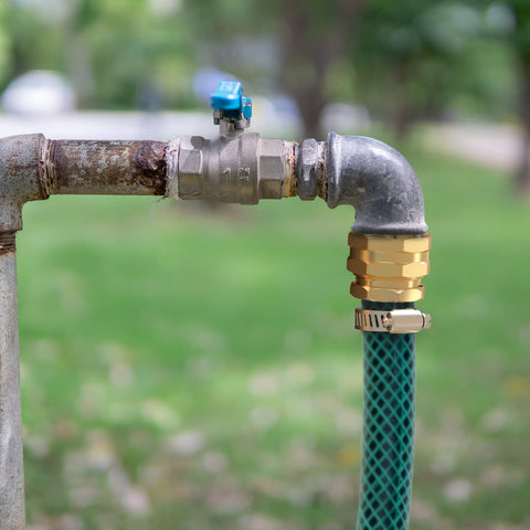 Connected garden hose with Garden Hose Repair Kit With Clamps Six Piece Set Male And Female Connectors For Three Quarter Inch Or Five Eighth Inch Hoses Aluminum Body With Copper Finish And Stainless Steel Clamps No Fuss Leak Fix And Quick Connect in outdoor setting.